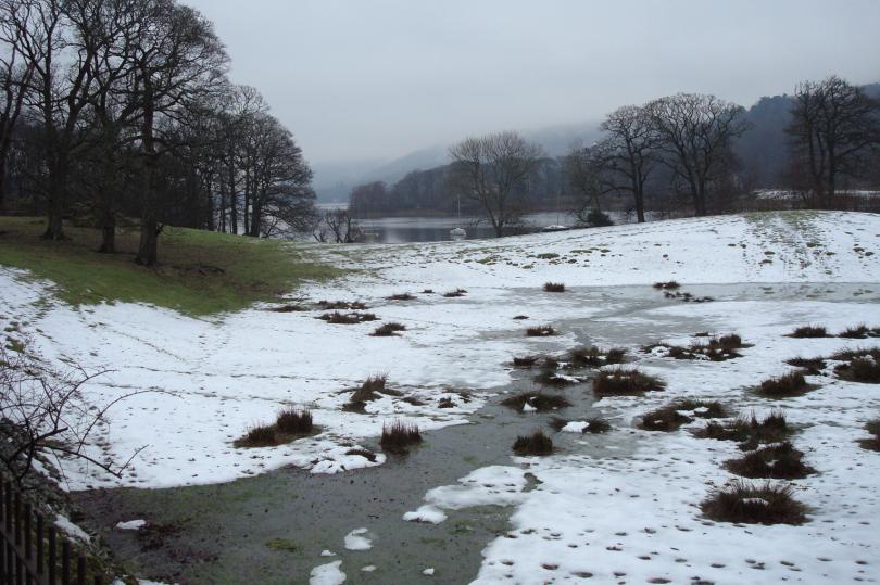 A wintry picture of Coniston water in the snow, with the clouds rolling in off the hills - perfect for a cosy night in front of the fire.